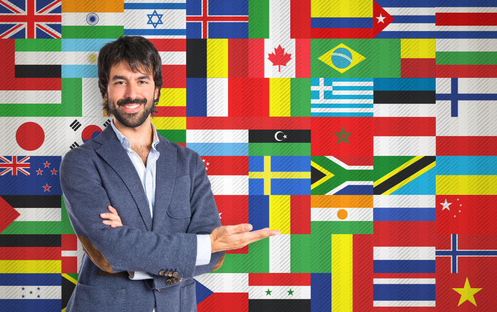 man in front of different flags